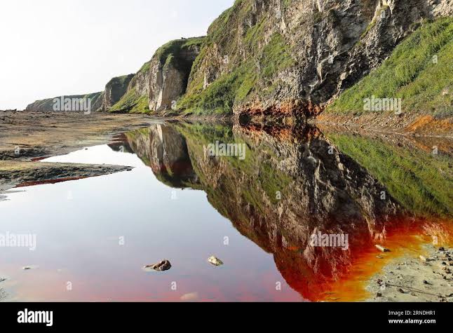 Blood red pools with yellow sulphur shores on the Blast Beach, Durham  Heritage Coast, Seaham, County Durham, UK Stock Photo - Alamy