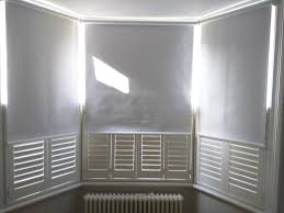 Typically, the width of your shutters should be half of your total window width. Blackout Roller Blinds With Cafe Half Height Shutters Bay Window Blinds Living Room Blinds Blinds For Windows Blinds Blinds For Windows Living Rooms