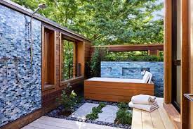 This spa area, located just off of a blue tiled pool, features a teak deck and wall. 15 Beautiful Outdoor Home Spa Design Ideas