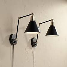 Bending gracefully from the wall, an iron base supports a sleek glass shade for a chic sconce. Plug In Wall Lamp And Sconce Styles Lamps Plus