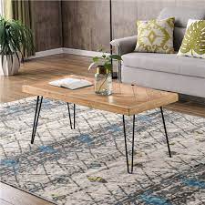 The rectangular table is made from solid mango wood and is supported by four hairpin legs with a gold finish for some retro vibes. Trexm Rectangular Nature Rough Wood Coffee Table Oak
