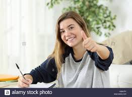 Happy Student Looking At You With Thumbs Up Sitting On The Floor Of Stock Photo Alamy