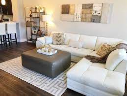 Let The Lights Shine On This Glamours Home A White Leather Sectional Offers The Perfect Contrast To Dark Wo Living Spaces Furniture Home White Leather Sofas