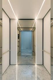Levele 105 Elevator Interior With Customized Panel Layout Minimal Panels In Bonded Quartz White With Elevator Interior Elevator Lobby Design Elevator Design