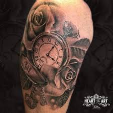 A tattoo designed to represent life can incorporate various living elements such as flowers or roses, while those meant to represent death might incorporate skulls, fire, or the grim reaper. Shoulder Clock Rose Tattoo By Heart Of Art