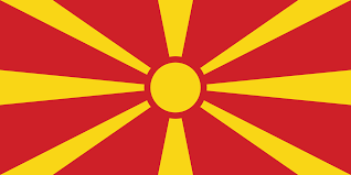 A felkelő nap nyolc sárga sugara piros háttér előtt jelenik meg. Macedonia Orszagok Zaszloi