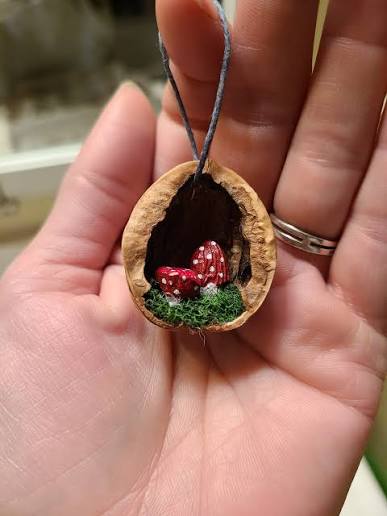 Hand carved and painted almond figures in walnut shell ornaments