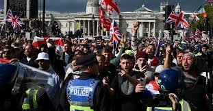 Police and protesters scuffle as 110,000 join anti-migrant London protest |  Reuters