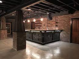 Epoxy flooring made for another industrial touch to the design and serves as an easy to clean surface for these dog moms. Industrial Basement Basement Bar Design Basement Bar Designs Rustic Basement