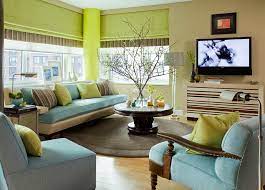 Cindy living room set light brown tufted sectional with loose, brown and beige accent pillows, brown ottoman and a beige, brown and gray rug. 25 Green Living Rooms And Ideas To Match