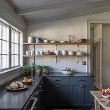 White and blue kitchen features white cabinets paired with gray granite countertops and backsplash. Blue Base Kitchen Cabinets Design Ideas
