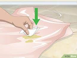 I'd use undiluted dish detergent on oily or greasy stains and rub well on the back of the fabric and use lukewarm water to rinse. 6 Ways To Clean Satin Wikihow