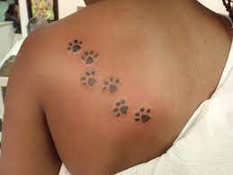 20 Amazing Paw Print Tattoos With Deep Connection Tattoos Win Pawprint Tattoo Tattoos Paw Print Tattoo
