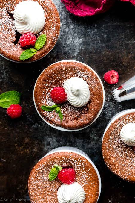 Chocolate Soufflé served with a dusting of powdered sugar and berries