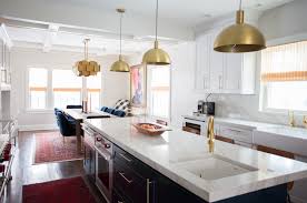 A kitchen island with legs carved out of a tree trunk adds a rustic touch to a kitchen interspersed with stone brick walls. Houzz Islands At The Center Of Most Kitchen Renovations Remodeling