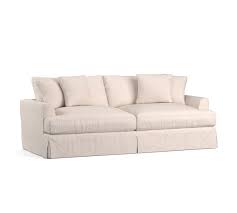 The wall sofa has a distinctive, regimented style featuring a square design and prominent corners. Sullivan Deep Seat Slipcovered Fabric Sofa Collection Pottery Barn