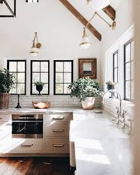 Modern Minimal Kitchen Design With White Marble Countertops Black Windowpanes And Hard Wood Flo Kitchen Inspirations Kitchen Interior Interior Design Kitchen