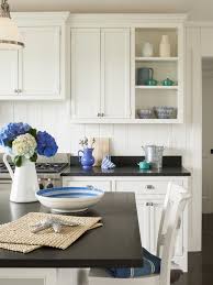 Beautiful fall kitchen decor with vintage wood bread boards and glass demijohns from boxwood avenue. Sophie Metz Design Absolute Black Granite Countertops White Kitchen Decor Blue Kitchen Decor