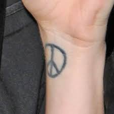 The peace symbol tattoo designs can be tattooed on any part of the body in a single tone like red, blue, violet, green or yellow. Peace Tattoo Design Amazing Tattoo Ideas