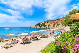Green hills and open plains become golden sand bathed in. Ibiza Island Spain May 18 2017 View Of Idyllic Beach Of Cala D Hort Wih Colourful Flowers In Foreground Ibiza Island Spain Stock Photo Picture And Royalty Free Image Image 93106036