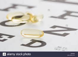 Vitamins Gel Capsules Lying On Eye Chart Stock Photo