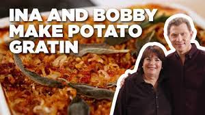 Garlic parmesan cheesy scalloped potatoes. Bobby Flay And Ina Garten Make Eleven Layer Potato Gratin Food Network Potato Gratin Recipe Potato Gratin Layered Potato