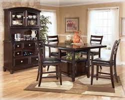 Natural walnut finish top and dark espresso finish base. Ridgley Dinette Set Ashley Furniture
