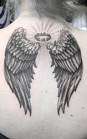 Features in this tattoo include a winged angel crushing the devil's head while lifting a sword. 150 Divine Angel Wings Tattoos Ideas Meanings Tattoo Me Now