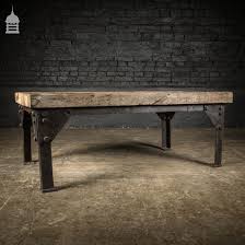 This industrial coffee table features a bamboo wood top and shelf with a walnut finish. Vintage Industrial Steel Base With Reclaimed Oak 3 Plank Top Coffee Table