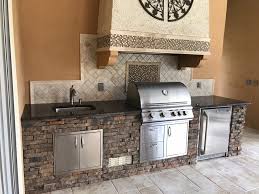 an outdoor kitchen with proper storage