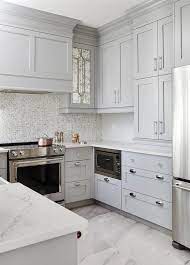White marble is beautiful and timeless, having been used in upscale homes and ritzy hotels for many years. Small Gray U Shaped Kitchen Clad In Polished Marble Floor Tiles Boasts Stacked Gray Shaker Cabinet Fi Kitchen Remodel Small Kitchen Layout Kitchen Design Small