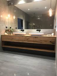 A double walnut vanity is topped with a clean white countertop in this chic bathroom. 17 Best Bathroom Vanities Design Ideas For Keep Your Bathroom Bathroom Sink Design Bathroom Vanity Designs Best Bathroom Vanities