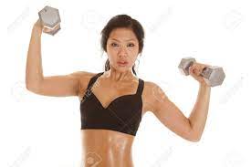 An Asian Woman In Her Black Sports Bra With Sweat Dripping Off Her Body  Lifting Weights. Stock Photo, Picture and Royalty Free Image. Image  18188009.
