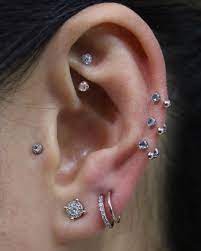 Image May Contain One Or More People And Closeup Earings Piercings Flower Earrings Studs Piercing Jewelry