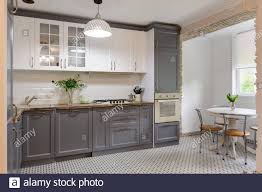 Dark grey kitchen with wood worktop ukg dimensions for pc. A Modern Grey Kitchen With White Counter Tops Lights Hanging Above The Island And Stainless Steel Wolf And Sub Zero Appliances Stock Photo Alamy