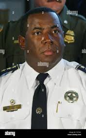 New Orleans Police Superintendent Warren Riley, center, shakes hands with  the Rev. Byron Clay, right, at an impromptu news conference in New Orleans,  Monday, Jan. 8, 2007. Members of the Southern Christian
