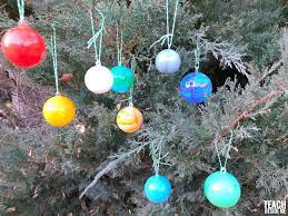 Made with natural materials featuring wood beads in red and neutral tones. Solar System Christmas Ornaments Teach Beside Me