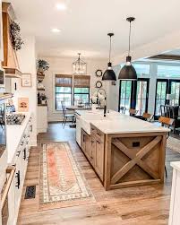 We saw the beginning of the love affair with two toned kitchen a couple years ago and this trend is still gaining popularity! Breathtaking Kitchen Island Lighting Ideas You Ll Immediately Want Farmhousehub In 2021 Rustic Farmhouse Kitchen Farmhouse Kitchen Design Modern Farmhouse Kitchens