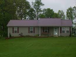 I have seen homes where the buyers love the inside of a home but are turned off by the roof. Red Metal Roof Tan Siding Click Pictures To Enlarge Tin Roof House House Roof Outside House Paint