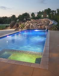 Beautiful Modern Pool With L E D Features Spill Over Spa And A Custom Rock Waterfall With A Built In Slide Luxury Swimming Pools Pool Waterfall Big Pools