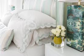 Contrasting finishes of the stained bed and the painted desk and bedside table create a balance in this stunning master bedroom. White And Seafoam Green Scallop Bedding Transitional Bedroom