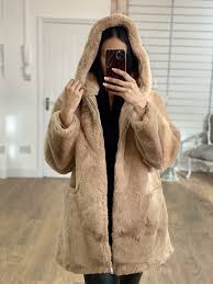 Faux shearling coat with slanted front pockets, three button closures and a large collar. Serine Camel Faux Fur Hooded Oversized Coat Bows Boutiques