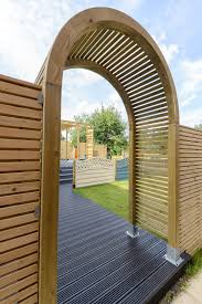 A simple wooden arch in a garden makes an ideal feature to divide it into separate areas or just for training decorative climbing plants. Contemporary Garden Arch Grange Fencing
