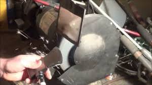 Method 1 sharpening a dull knife on a manual sharpener. How To Sharpen A Hatchet Or Axe Using A Benchtop Grinder Youtube