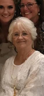 Hello, please can someone edit this photo to take out the people in the  water and some of the boats/boards so it's more clear around my auntie and  her children? It's for