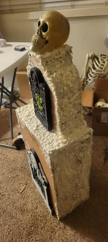 DIY cardboard tombstones with foam paint and dollar tree decorations