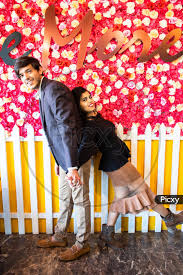 Image of Young Happy Cheerful Indian Couple In Love Have Fun Together  Against Floral Background, Boyfriend Girlfriend Relationship, Enjoy Life,  New Year Or Valentines Day.-HP515916-Picxy