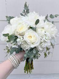 Here is list of the 25 most beautiful white flowers in the world! Elegant White Bridesmaid S Bouquet Composed Of Peonies Stock Garden Roses Ranunculus And Eu White Wedding Bouquets Wedding Flowers Bridesmaid Bouquet White
