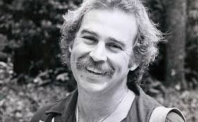 Oldie but a goodie. 1972. A very young Jimmy standing next to a very young  John Prine. . Jimmy in a tshirt with a bottle of Ripple wine