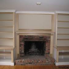 A Book Shelf Surrounding A Fireplace Built In Around Fireplace Built In Shelves Living Room Fireplace Built Ins